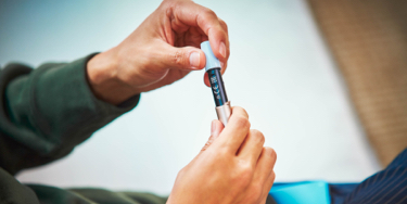 Man cleaning his IQOS holder